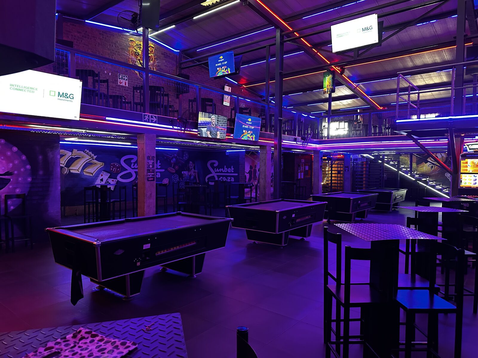 Pool tables and high tables under the mezzanine at Cheeky Tiger Midrand