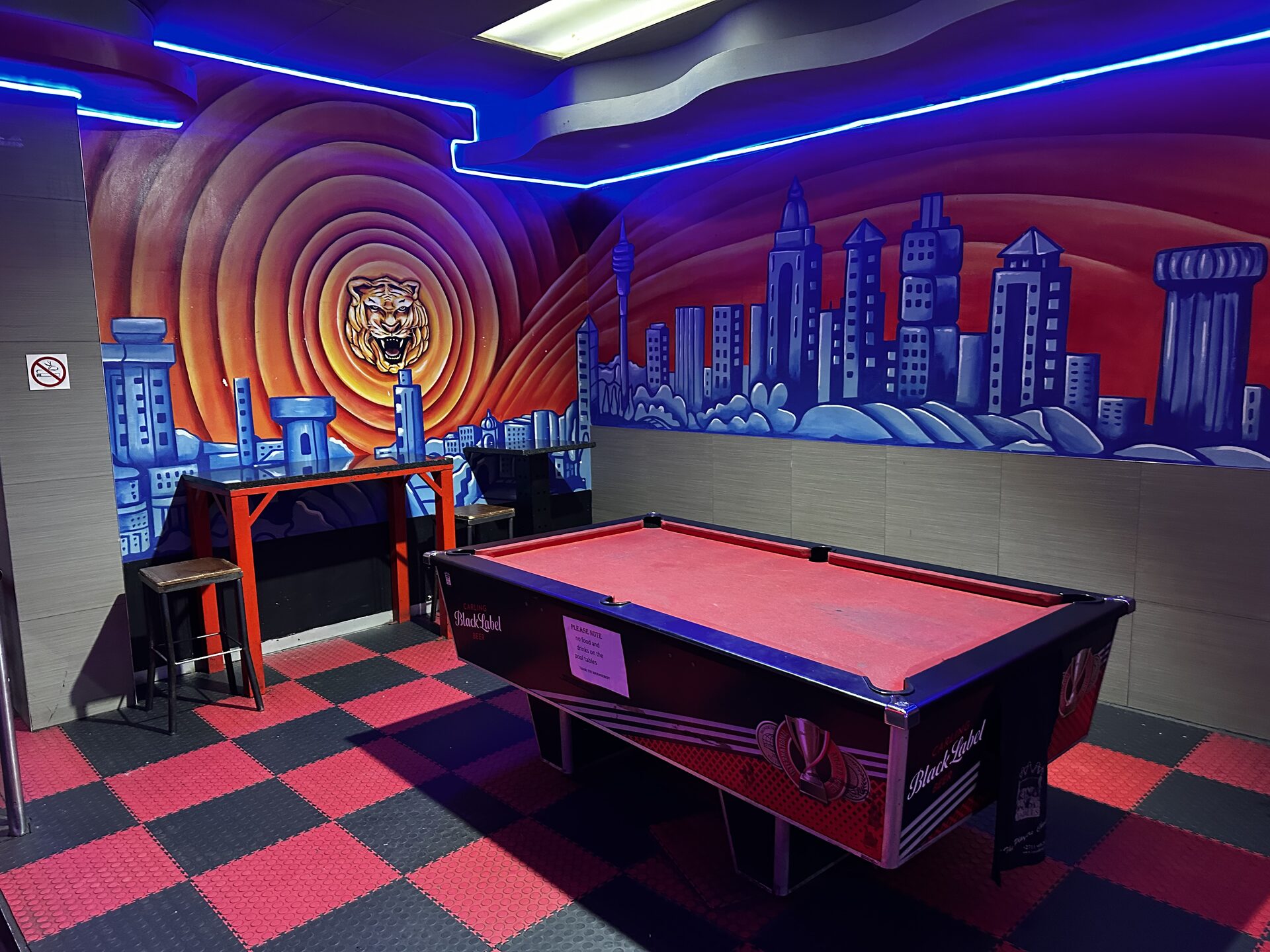 Pool table and hand-painted tiger skyline mural in the games room at Cheeky Tiger Kempton Park